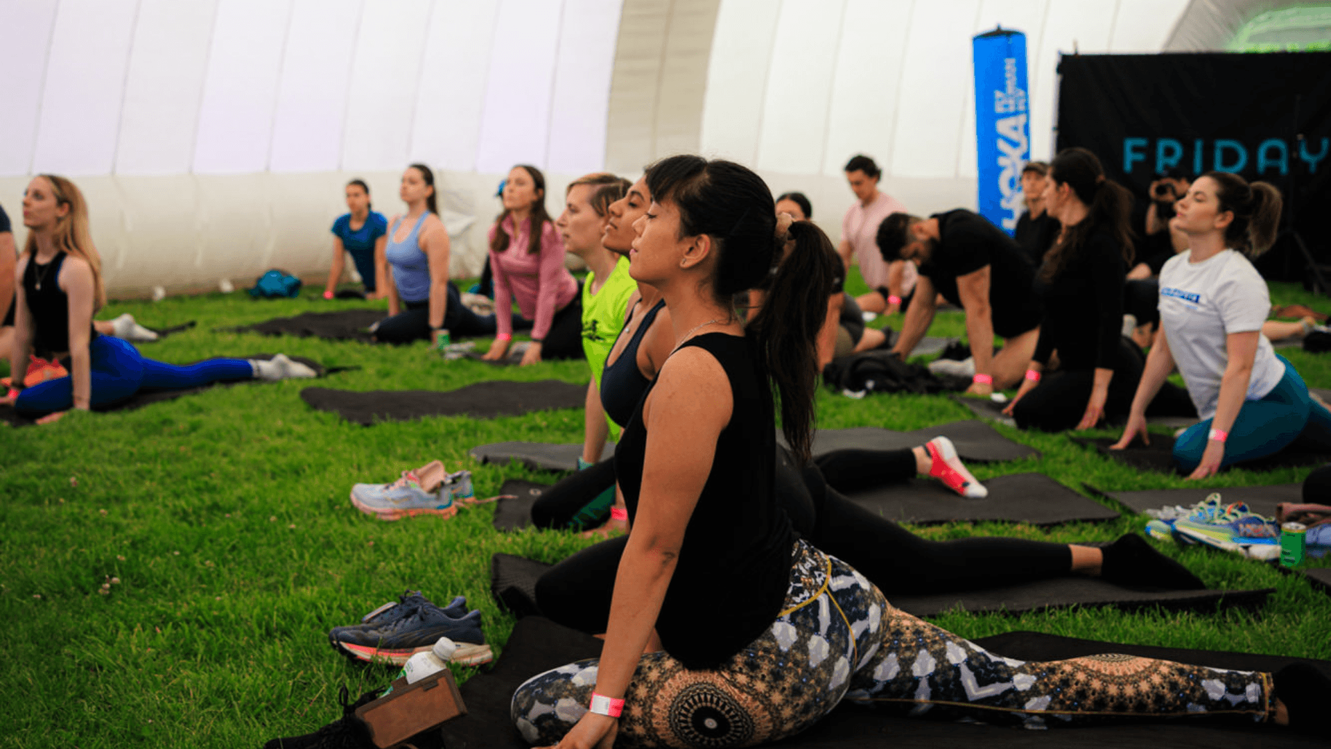 Group of runners taking part in a Yoga event inside the dome at Friday Night Lights
